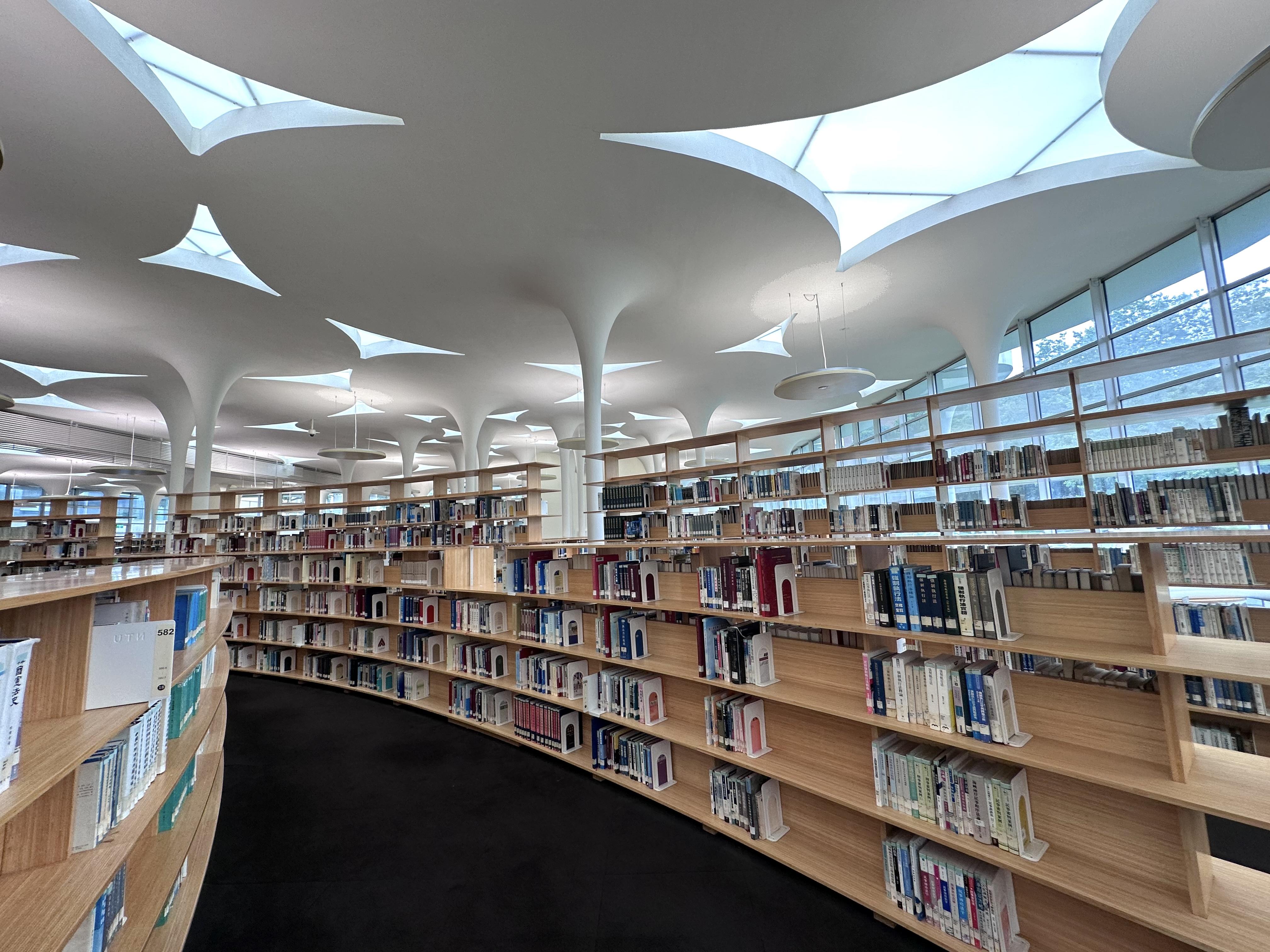 660組竹造的弧形書架,以螺旋線式配置於樹狀柱之間。