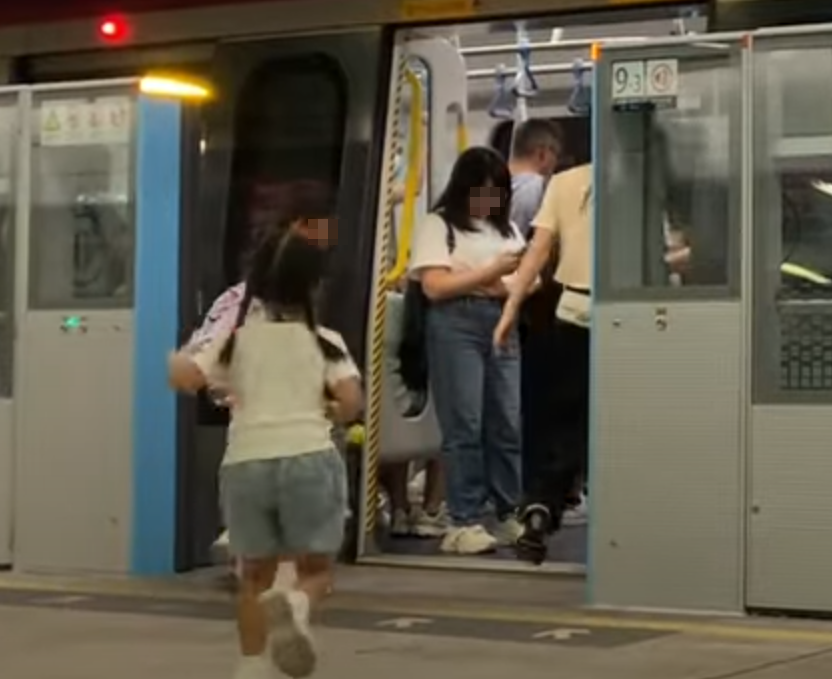 帶着一對仔女的母親於港鐵落馬洲站時情急衝門,惟她未有拖實二人,與緊跟其後的兒子及時進入車廂(影片截圖)