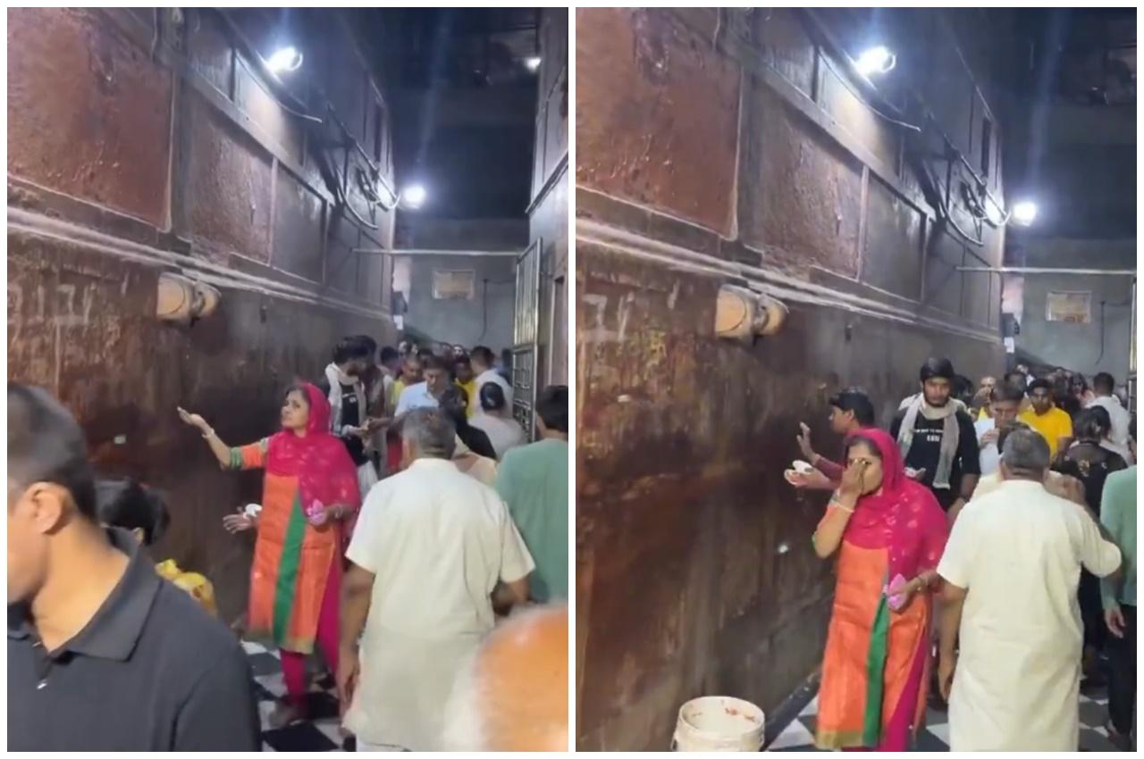 雕像前聚集了大批民眾,有人用手或用器皿接「聖水」享用,亦有人將水塗抹頭部身體。(X)