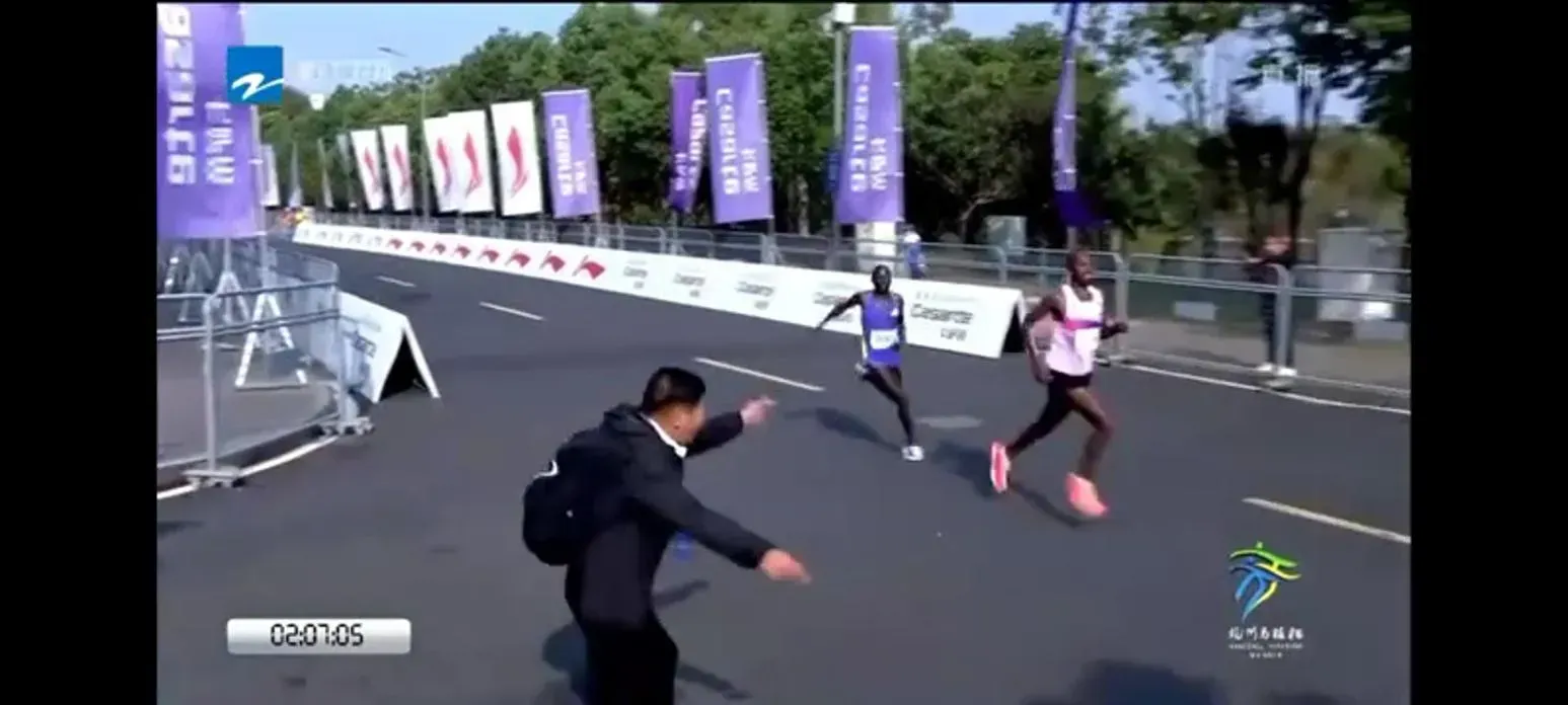杭州馬拉松2024,Moses Kibet(紫衫)在賽事末段落後Tesfaye Deriba(白衫)。