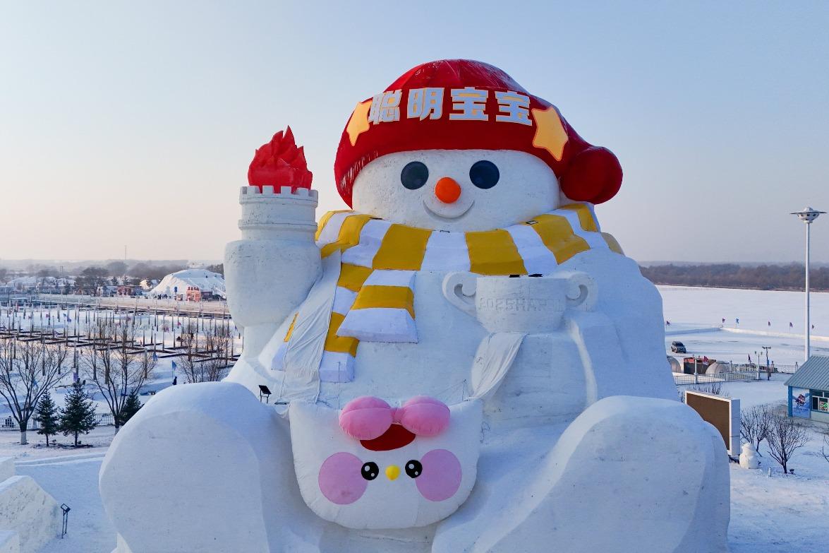 哈爾濱外灘雪人碼頭的火炬雪人,戴上紅色帽子和條紋圍巾,搭配圓滾滾的雙眼,可愛滿分。(圖片來源:視覺中國)