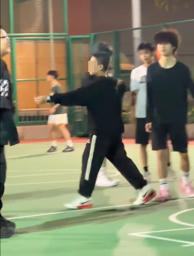 中間的黑衣男童把香煙遞給另一男童。(片段截圖)