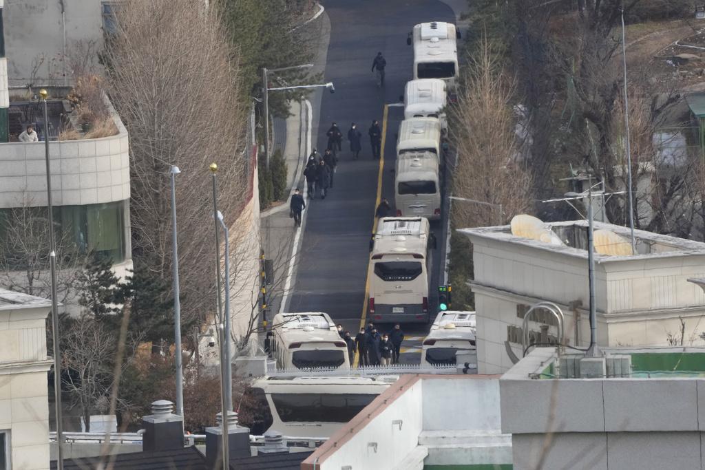 南韓總統官邸外設置「巴士陣」阻攔公調處執行拘捕,周三早上有保安人員進行部署。(美聯社)