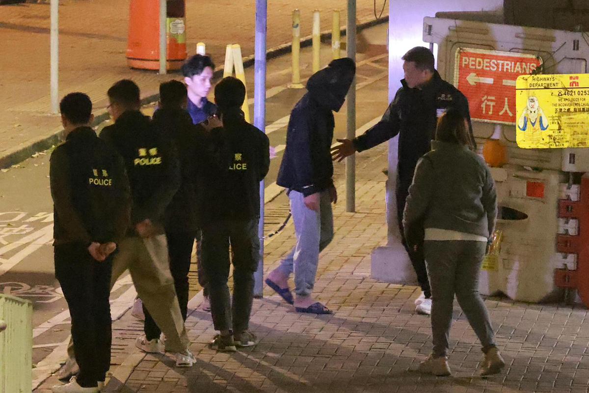 男疑犯被捕翌日後被黑布蒙頭押返現場重組案情。(資料圖片)