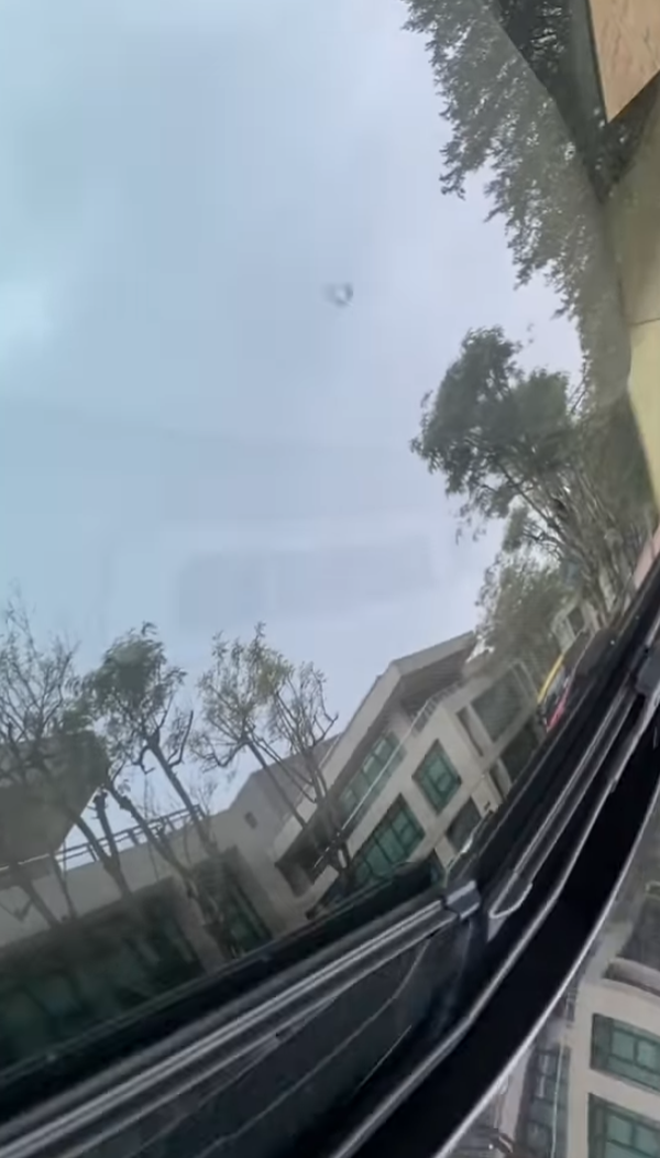 司機下車後展示3支扭曲變形的條狀物,近鏡所見為鋁條,私家車車頭冚及擋風玻璃有刮花損毀㾗迹。(facebook香港突發事故報料區影片截圖)