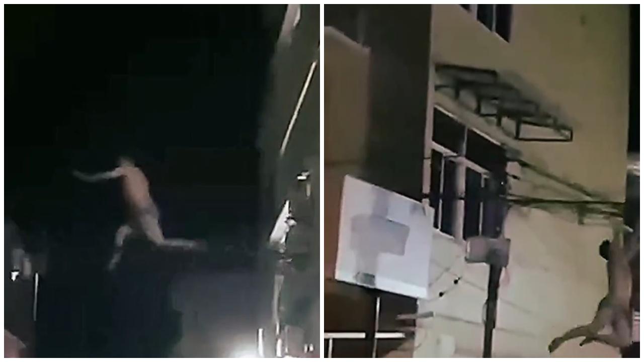 男子躍出平台,用手抓住與對面建築物之間的電纜。(X)