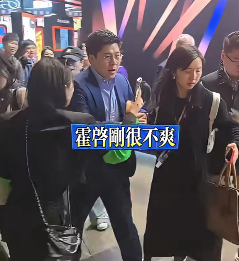 霍啟剛遇到多名人士死纏強行自拍阻擋去路,行為過火,令霍啟剛罕有一度黑面,向對方解釋之後仍不得不合影。(影片截圖)