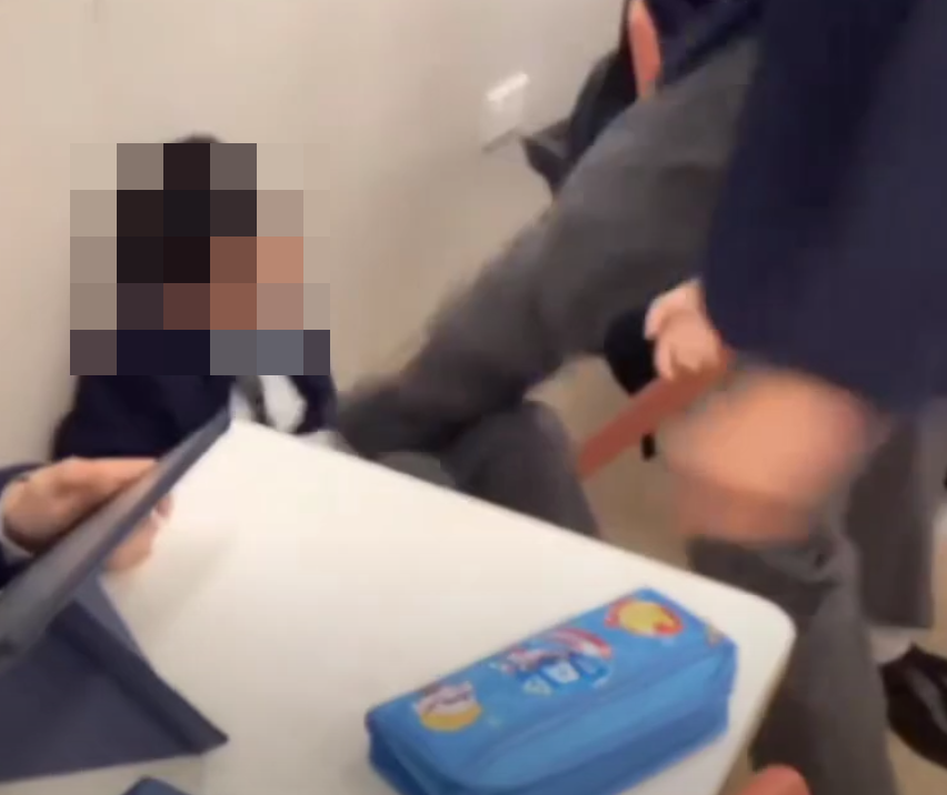 網上近日流傳影片,顯示有兩名男學生在課室內打架,有人被拳打頭部推倒在地後再用腳踩,躺在地上哭泣。根據校服和窗外環境,疑是中西區名校聖保羅書院。(影片截圖)