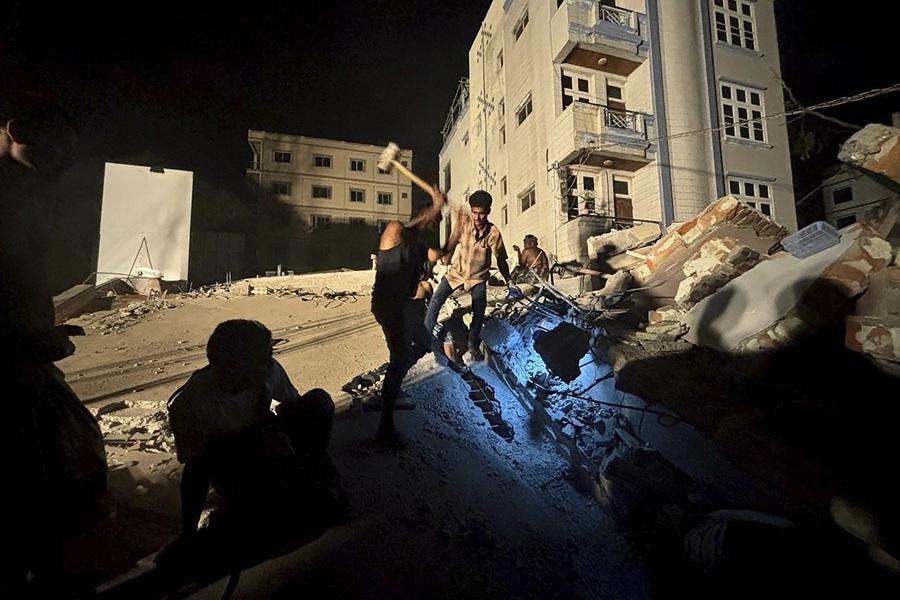 緬甸地震|曼德勒居民徒手挖掘瓦礫拯救被埋親人。(美聯社)