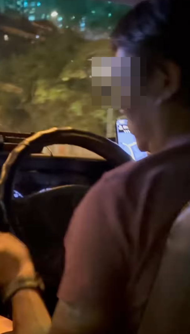 的士司機被拍得邊駕車載客邊剪指甲(fb香港交通及突發事故報料區影片截圖)