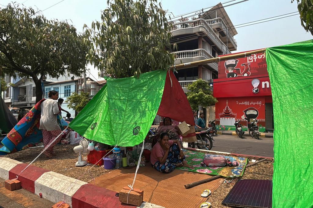緬甸地震災情,圖為曼德勒居民周二在簡陋的帳幕下樓身。(美聯社)