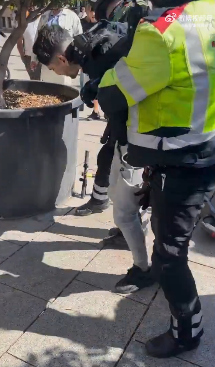 山東一名青年近日在西班牙巴塞隆拿街頭遇到小偷,當場使出鎖喉招式把對方制服,獲當地警員和市民讚賞。(影片截圖)