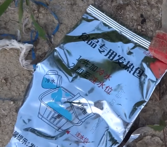 西貢萬宜水庫東壩近日成為遊客旅遊熱點,有網民近日於東壩近破邊洲一處泥地發現大堆垃圾,大部分食物包裝均印有簡體字,立即拍片公審,擔憂污染水源及郊野環境。(fb影片截圖)