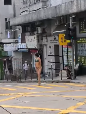 有網民上載影片,現場在西營盤西邊街及皇后大道西交界,一名身穿三點式泳衣高跟鞋的長髮女子,在班馬綫展示其「健美」身段,當時行人過路交通燈為綠色人像,女子期間挺胸收腹、撥頭髮轉身翹股,讓前方及行人路的兩名攝影師拍攝,可見她似乎有一定拍攝經驗,途經市民紛紛注視,更有年輕男子加入「打卡」行列。(IG影片)