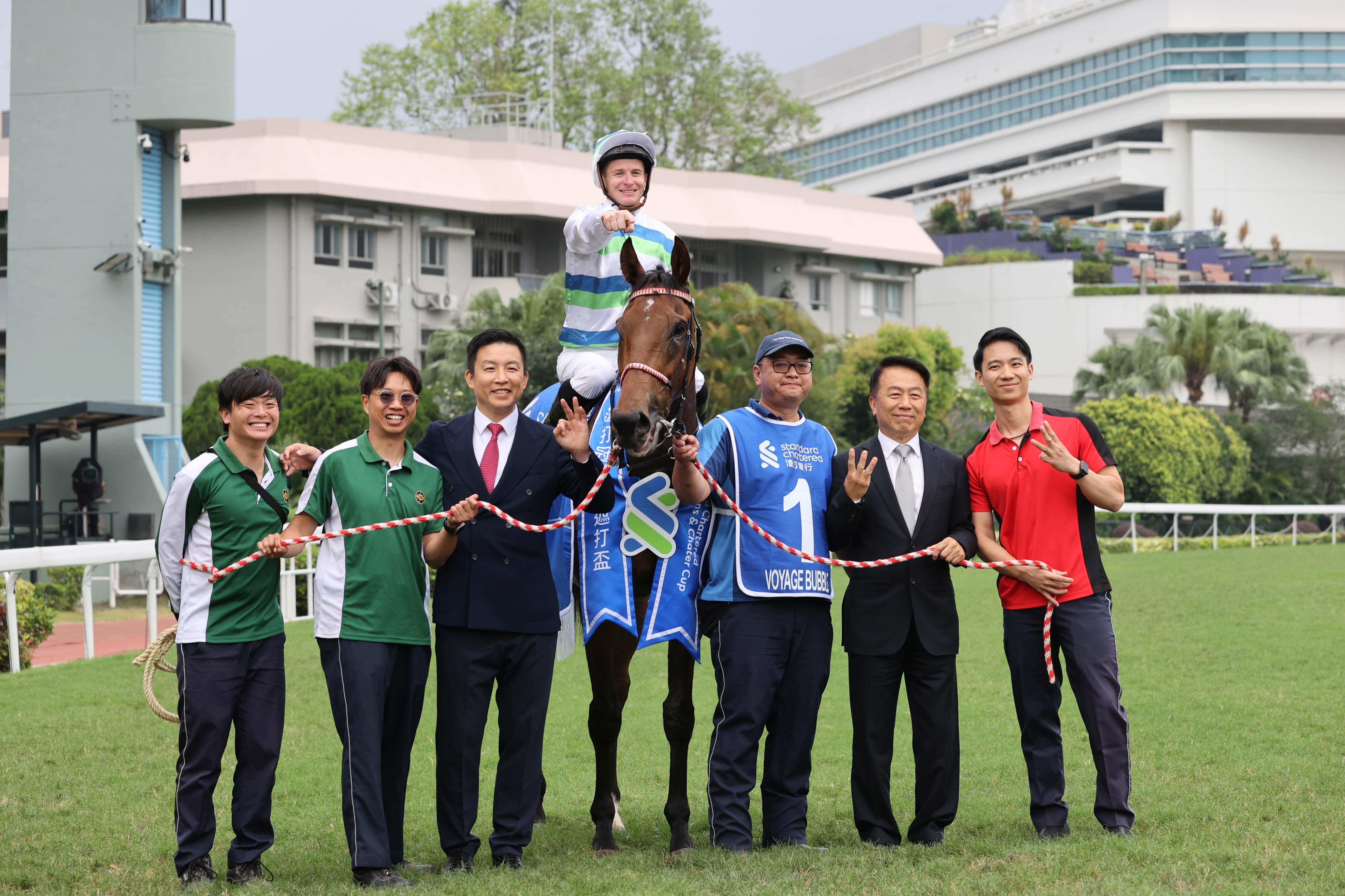 「遨遊氣泡」的練馬師姚本輝(右2)及馬房團隊賽後祝捷。(大會提供)