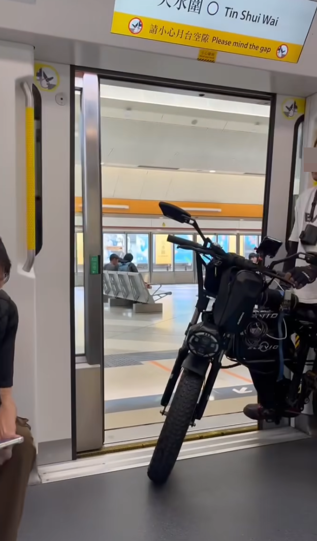 社交平台流傳影片及照片,一名金髮男子坐疑似電動單車乘搭港鐵屯馬綫列車,於天水圍站一度阻礙其他人上車。(屯門友FB)
