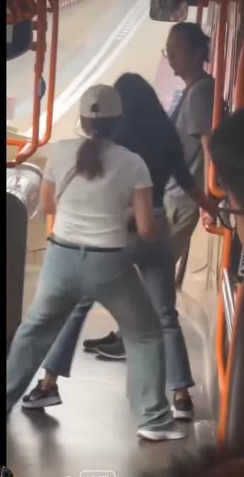 網上熱話|失常女子大鬧機場巴士 爬行李架又跳舞 中年漢仗義制止 (@fb Sam Hk影片截圖)