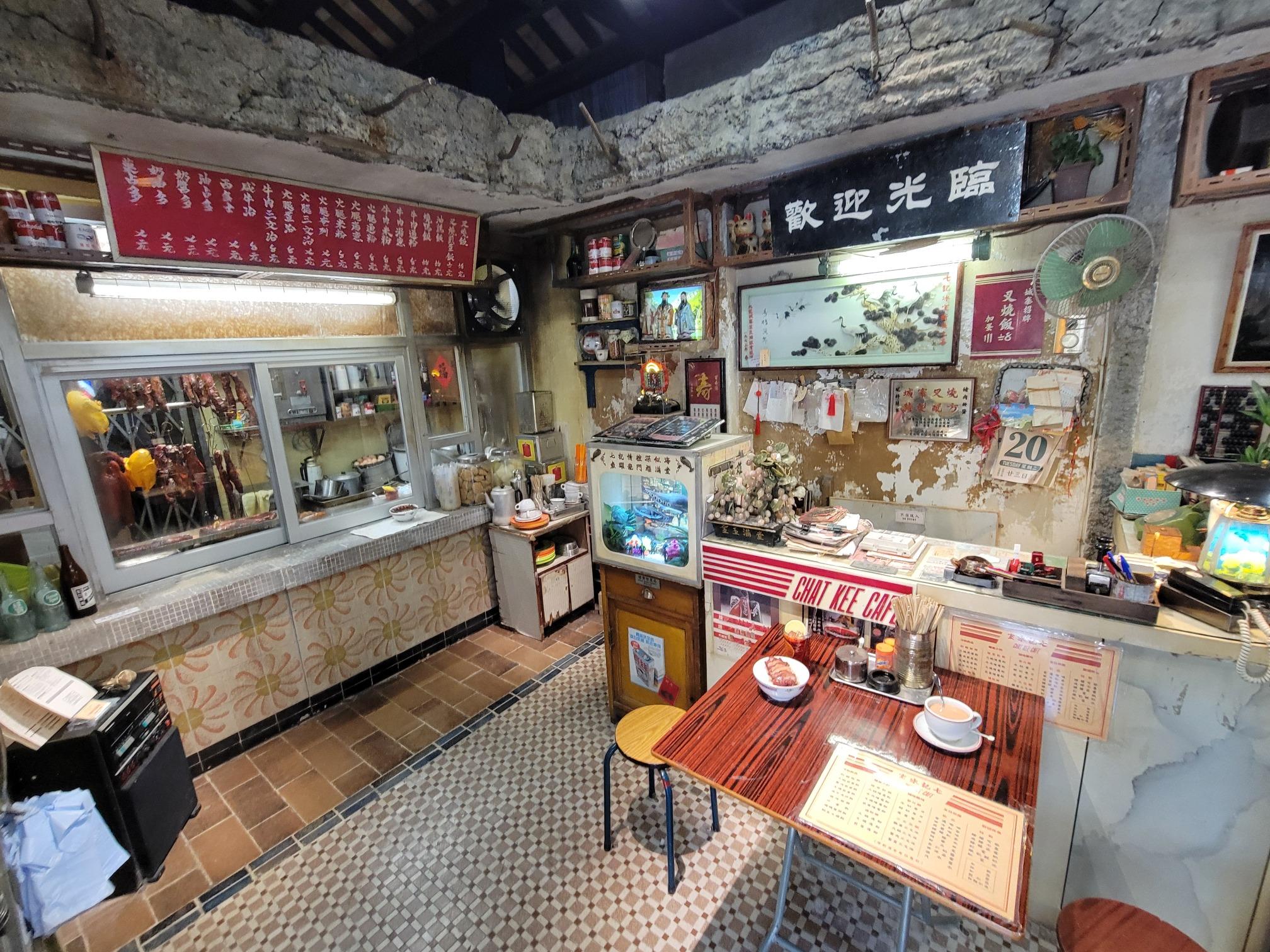 電影中陳洛軍初到九龍城寨,龍捲風將他安置在兄弟「阿七」所開的七記冰室。電影場景的餐桌上放有招牌叉燒飯。(圖片來源:當代中國攝)