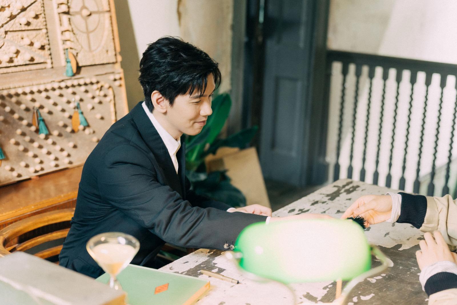 Phil於MV中化身為一位酒店前台職員。