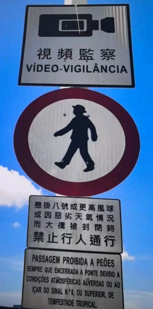 澳門兩名旅客推着行李箱,經嘉樂庇總督大橋由澳門半島行向氹仔。治安警察局接報後,協助兩人返回安全地點,由於兩人違反現場按道路交通規章相關規定設立的禁止行人通行符號,已依法被檢控。(澳門治安警察局)