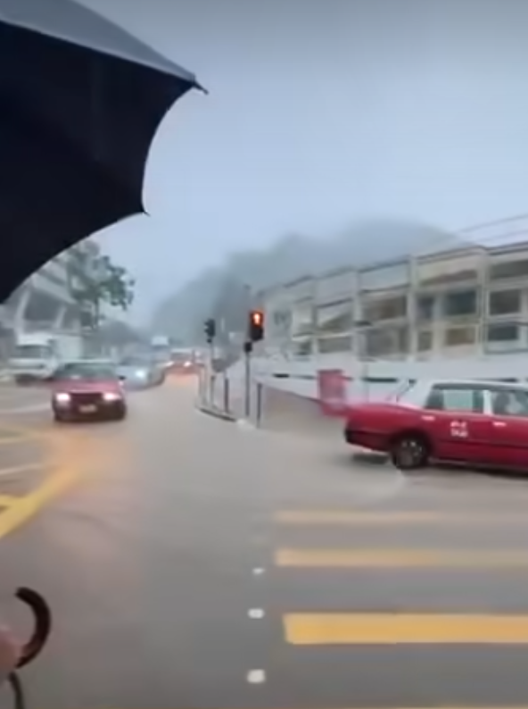 有網民在柴灣道近東區醫院的路口拍片,可見馬路及行人道水浸嚴重,汽車行駛時不斷將雨水掃上行人道,多名上班族不知所措,一名穿裇衫的男子一邊以左手擔遮,冒險雙腳站上離地約1米的防撞欄上行走避開泥水,期間以右手扶着欄杆。(車cam L(香港群組)fb)