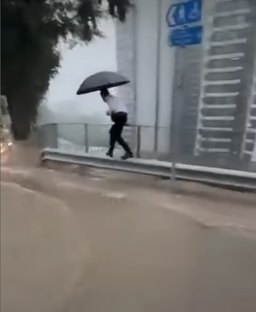 有網民在柴灣道近東區醫院的路口拍片,可見馬路及行人道水浸嚴重,汽車行駛時不斷將雨水掃上行人道,多名上班族不知所措,一名穿裇衫的男子一邊以左手擔遮,冒險雙腳站上離地約1米的防撞欄上行走避開泥水,期間以右手扶着欄杆。(車cam L(香港群組)fb)