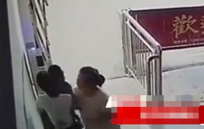 婦人正迎面而來,突然摟著男抱住,將湊去男童的面臉。(微博)