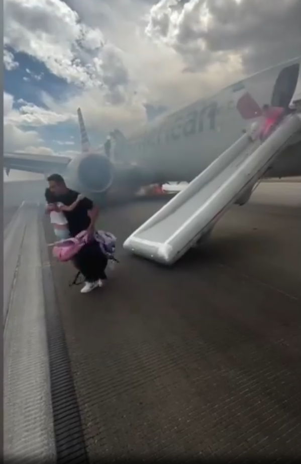 美國航空波音客機跑道冒煙起火 173乘客驚險逃生(有片)