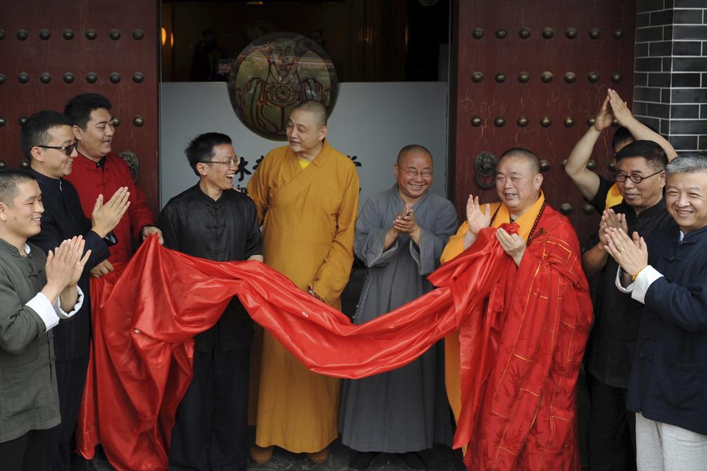 現年60歲的少林寺方丈釋永信(右三)被爆曾與美女在香港五星級酒店開房。(AP)