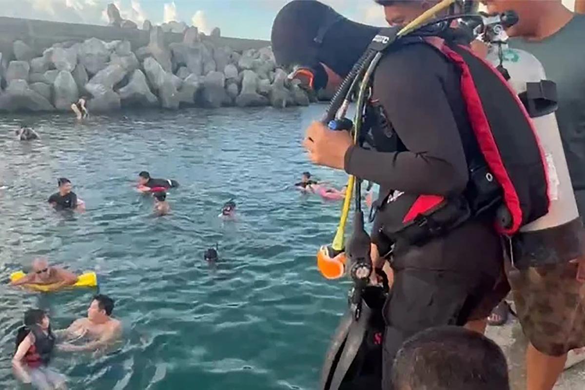 海巡人員落水協助將電單車拉回上岸。(海巡署圖片)