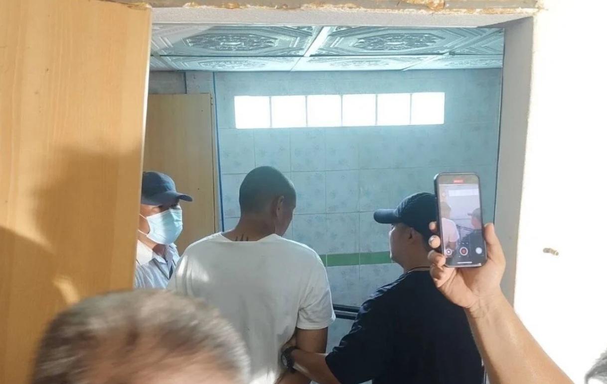 警員押解塔恩回案發單位調查。(互聯網)