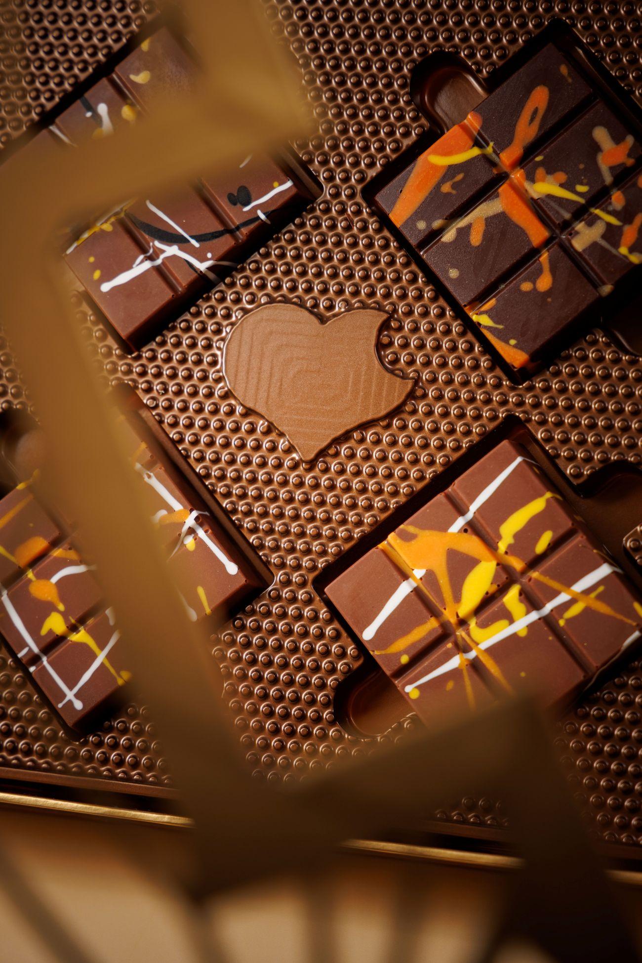 一盒四件朱古力月餅,內有兩件「鹹蛋黃奶黃脆牛奶朱古力」、「芝麻脆牛奶朱古力」及「花生醬脆黑朱古力」各一。