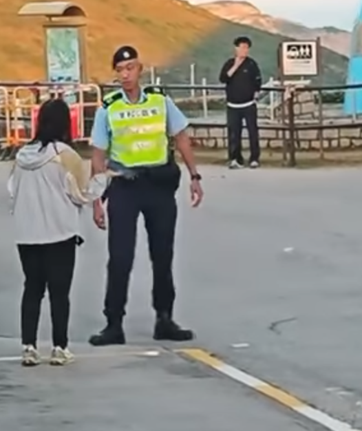 西貢萬宜水庫東壩多名排隊等候人士鼓噪不滿有旅客沒排隊就登上小巴,其後獲警員告知是「包車」。(影片截圖)