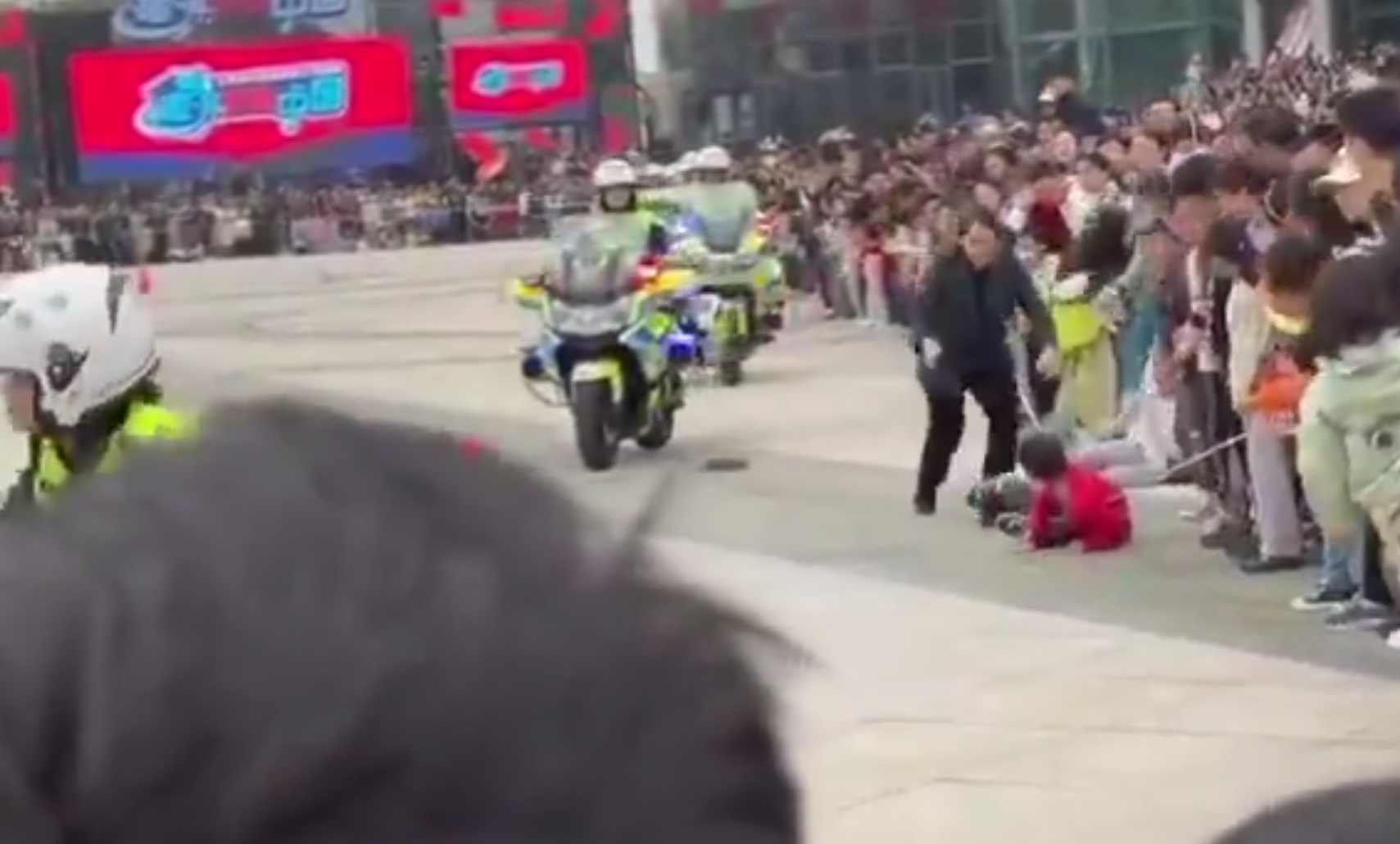 江蘇蘇州公安局一名女交通警駕鐵騎表演期間,失控撞上人群,惟事發後女交警只顧查看車輛受損狀況,及找同僚協助扶正車輛,未前往被撞小孩了解傷勢,惹來網民狠批。蘇州市公安局交通管理局誠懇致歉。(影片截圖)