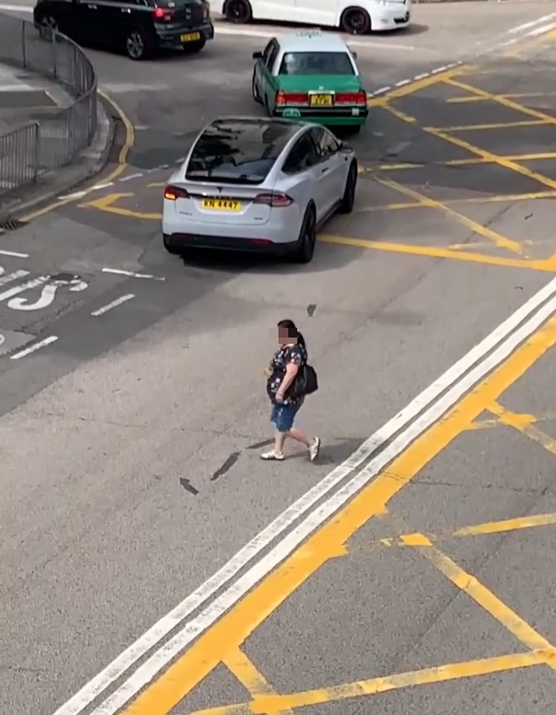上水一名婦人「打斜」橫過馬路,走到對面巴士站時遭守候警員「斷正」,但婦人看到警員後「揮了一下手」未有停下,警員逐跟在身後走了幾步,最終成功截停對方。(Threads影片截圖)