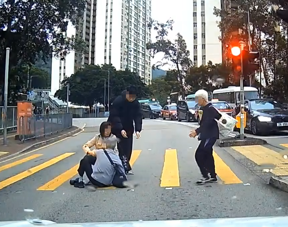 一名婆婆過馬路疑因綠燈正在「閃燈」,情急下失平衡在路中心向前仆倒,連鞋也甩脫,附近一對男女見狀即上前協助扶起 (facebook群組「車cam L(香港群組)」)