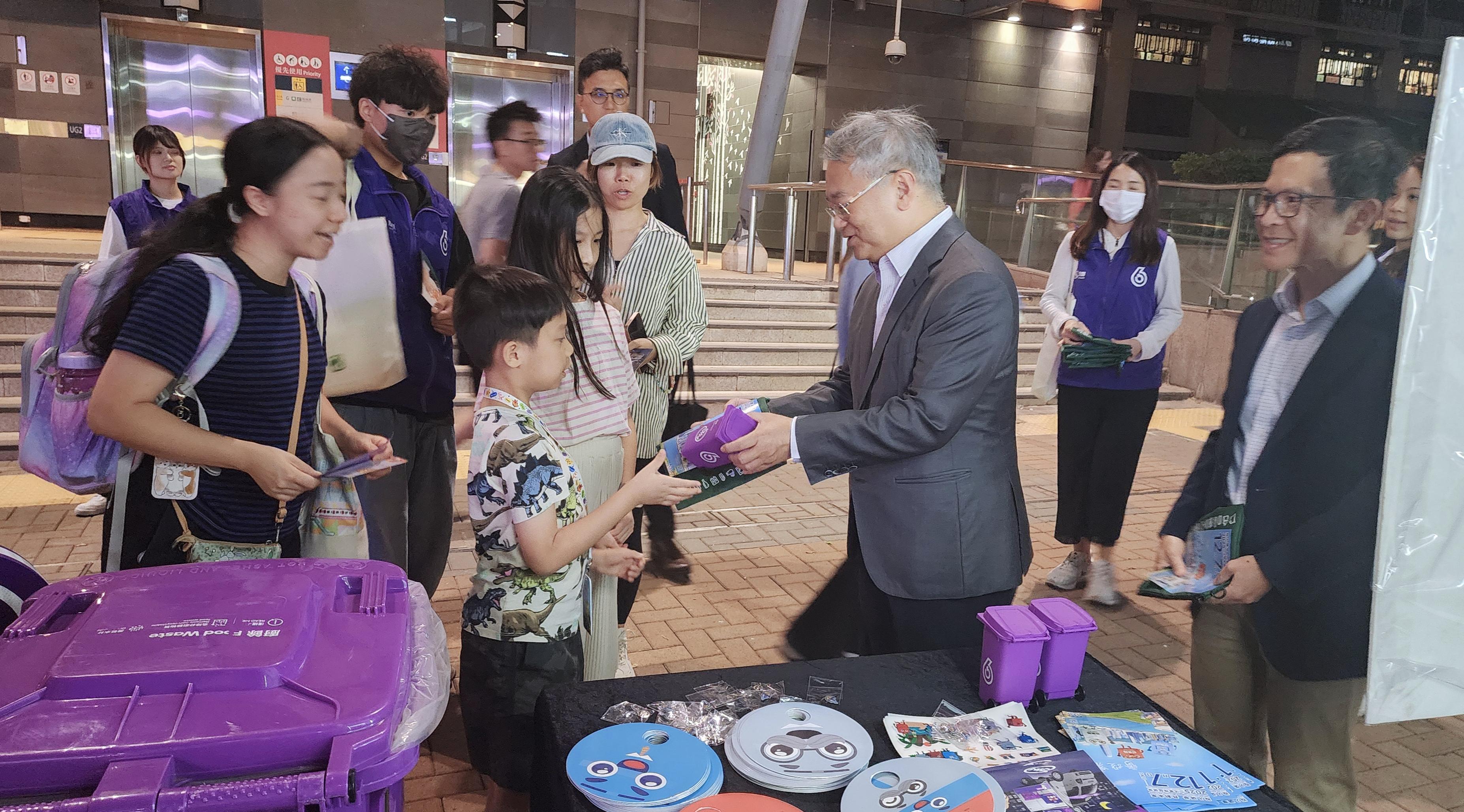 圖示徐浩光(右二)和鄭健(右一)向市民派發紀念品。(政府新聞處)