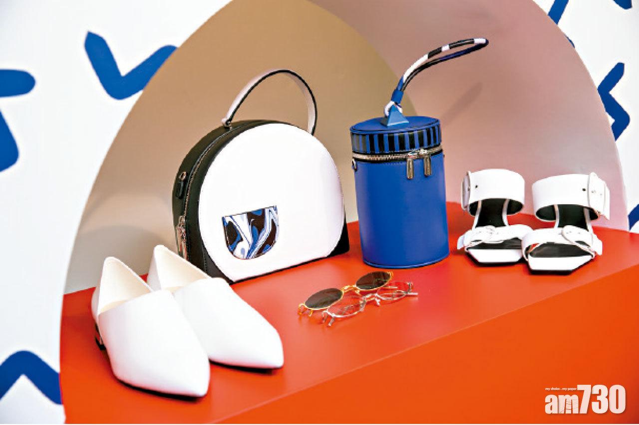 大膽剪裁的手袋,為造型添亮點。