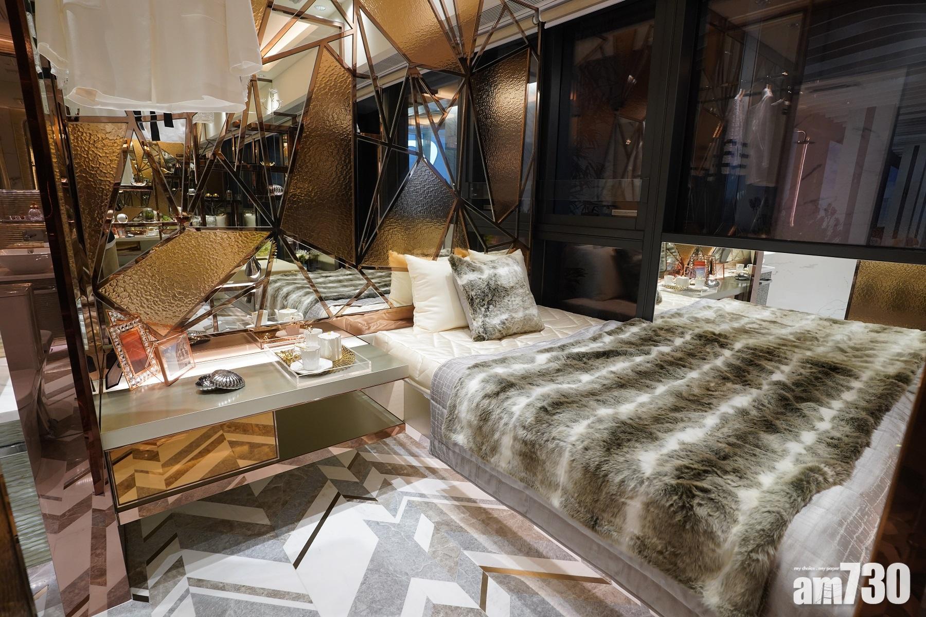 18E單位睡房床背設有玫瑰金藝術圖案,鑲嵌著鏡子及浮雕金屬板。於落地玻璃旁邊放置一張雙人床,布局簡單。(陳奕釗攝)