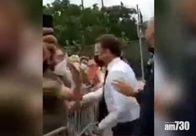 男子(左)出手掌摑馬克龍(穿白襯衫)。(互聯網)