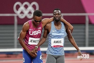 互相攙扶並肩走向終點。(美聯社)