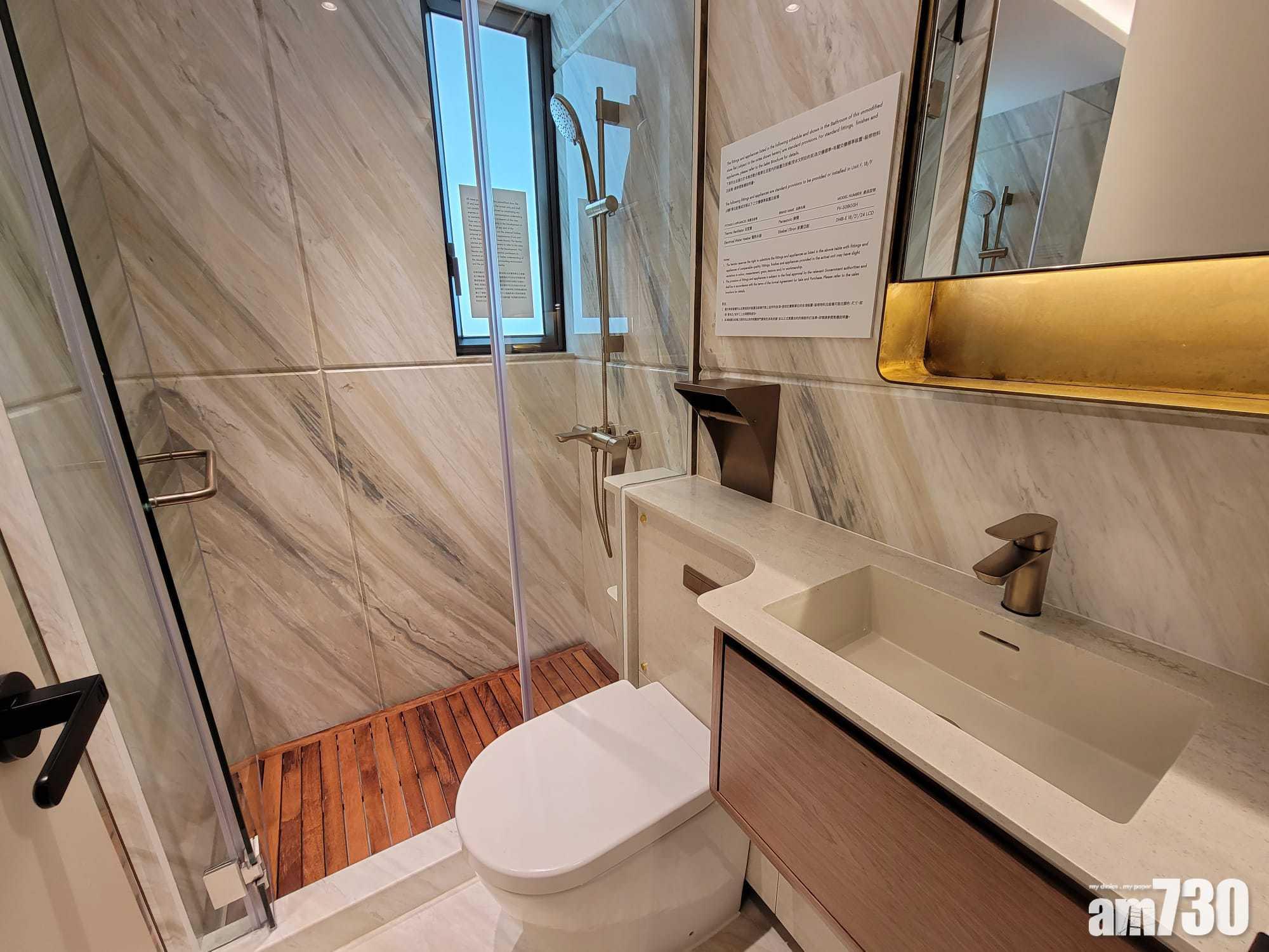 開放式示範單位浴室以天然石材鋪砌,為「明廁」設計,有助排走濕氣,不過廁紙架安裝於坐廁頂,並非一般常見的安裝於坐廁旁邊。(莊振邦攝)