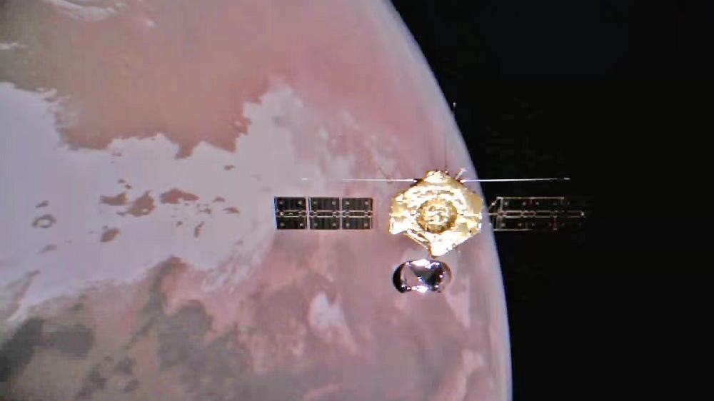 天問一號今年元旦傳回的環繞器與火星合照。(新華社)