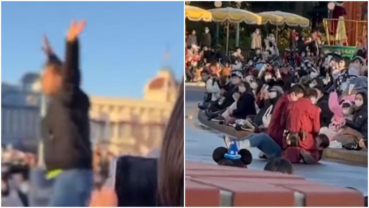 黑衣男闖東京迪士尼花車巡遊秒被制服，卡通人物專業繼續搞氣紛。(Twitter)