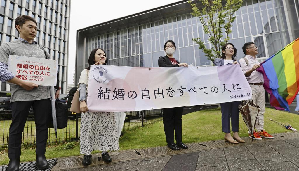 福岡法院宣布裁決前，律師在法院外展示橫額，要求實現婚姻自由平等。(美聯社)