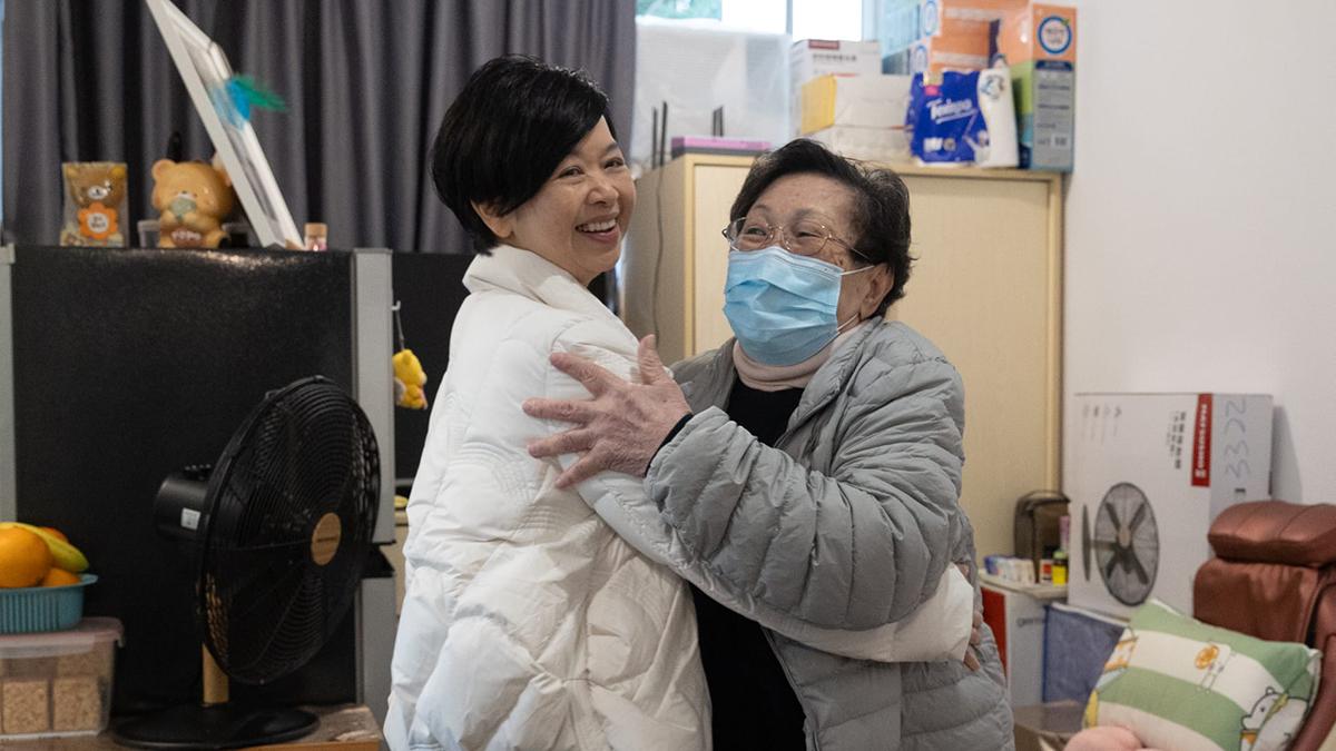 何永賢(左)上門探訪獨居長者。(蘇文傑攝)