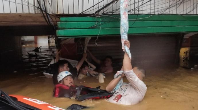 湖南水淹街道，3男水中輪流托高孕婦3小時直至獲救。(微博)