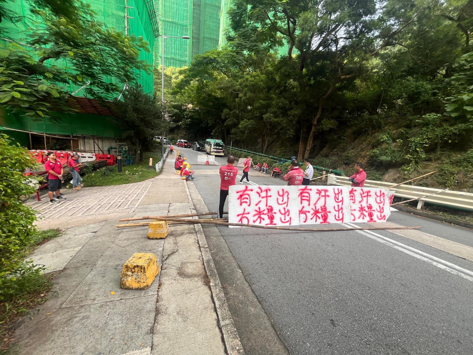 火炭穗禾苑外牆維修工程出現欠薪風波。約20名工人在巴士站對開路面拉橫額「有汗出冇糧出」、「還我血汗錢」，並擺放竹枝擋堵路。(網上圖片)