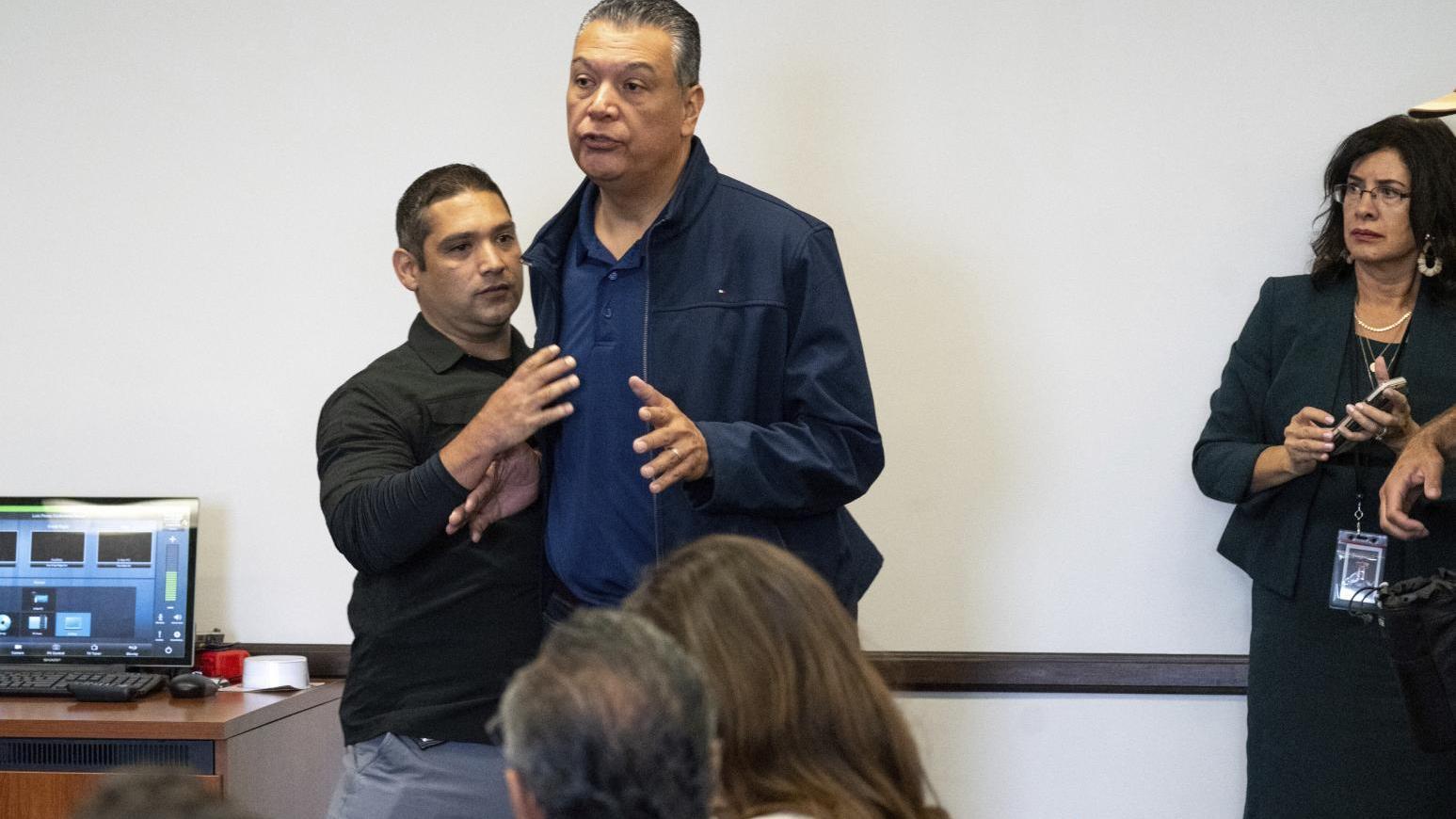 加州聯邦參議員帕迪亞（穿外套者）被強行推出場外。（圖／美聯社）