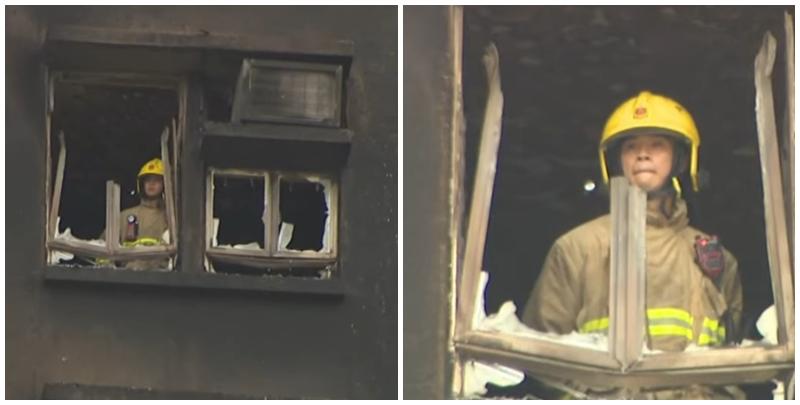 大埔宏福苑五級火，一名消防員登上一個已遭嚴重焚毀、窗框破爛的單位視察，不時望向窗外凝視接近5分鐘，期間若有所思神色凝重咬唇。(有線新聞畫面)